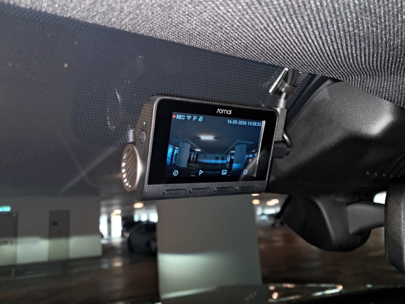 70mai A810S front dashcam neatly tucked behind the rear-view mirror of a BMW X3, wiring fully hidden